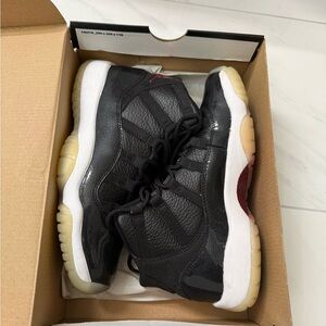 Nike Air Jordan 11 Retro BG sneakers in a black, gym red, white, and anthracite